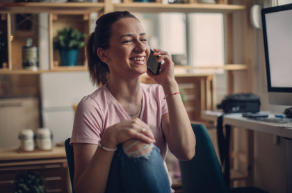 Woman holding phone and smiling