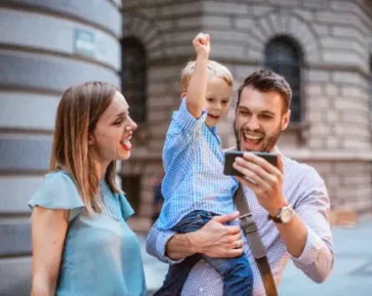 Family watching phone together cheering