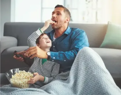 Family watching phone together cheering