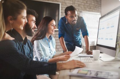 Four people around computer