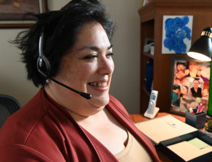 Woman sitting at desk wearing a headset
