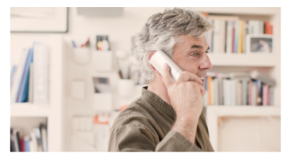 Man holding home phone up to ear