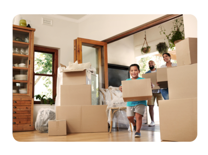 Family moving into home with stacks of cardboard boxes