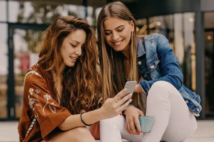 Two people browsing on a phone.