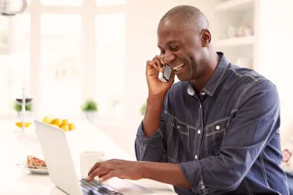 A person chatting on the phone at home.