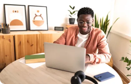 Guy looking at laptop and smiling