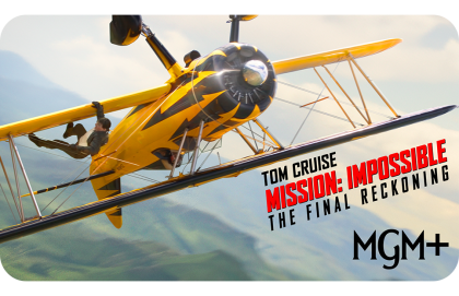 Tom Cruise hangs from the wing of a yellow biplane in mid-air for Mission: Impossible – The Final Reckoning on MGM+.