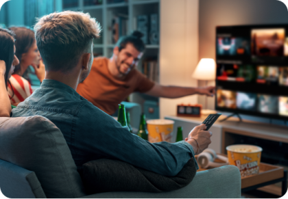 Friends sitting in living room looking at TV