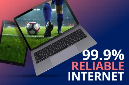 A laptop and tablet displaying a soccer game with the text "99.9% RELIABLE INTERNET" on a blue and pink gradient background.