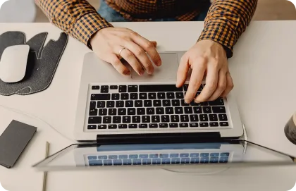 A person typing on a laptop.